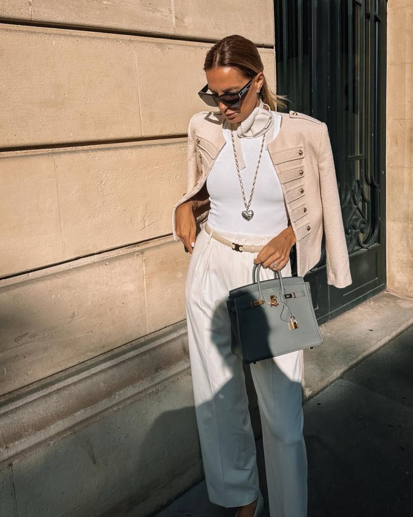 Elegant spring outfit with cream military jacket, white bodysuit, straight leg trousers, metallic belt and sage structured bag | luxury minimal style
