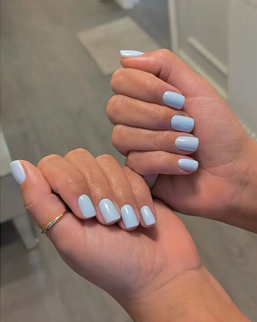 Short square powder blue nails with glossy finish creating a serene spring old money aesthetic