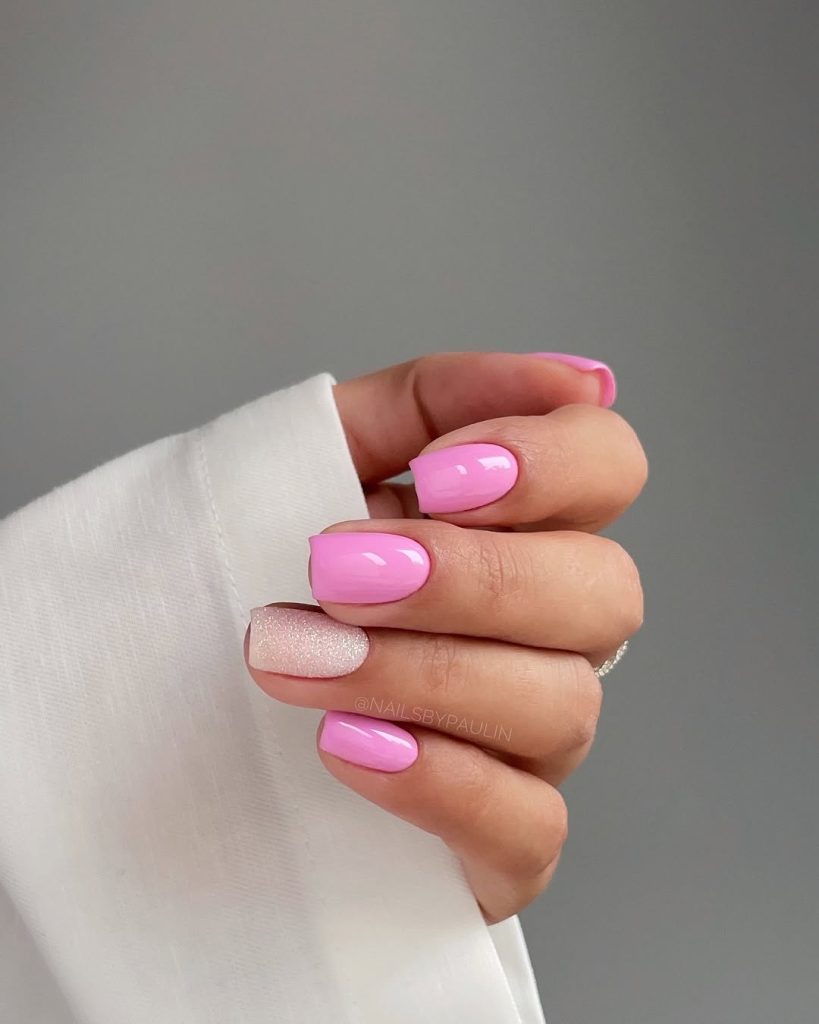 Short classy pink nails and shimmery white nail accent
