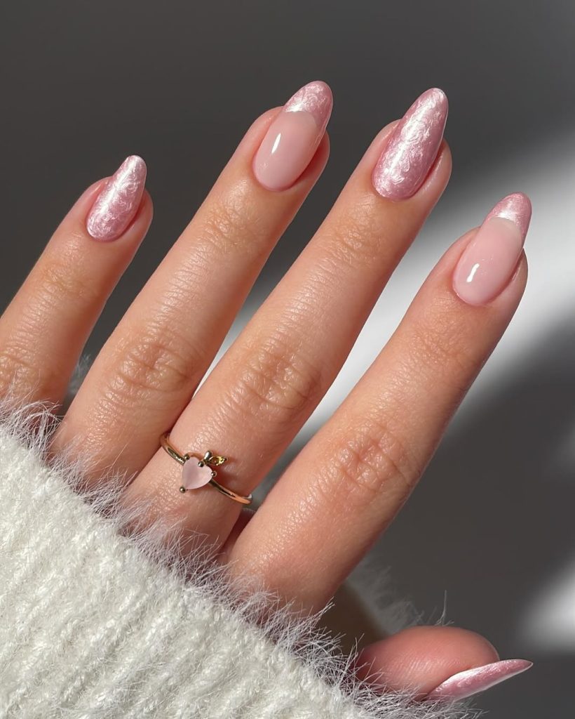 Almond nails alternating between pearl pink French tips and full pearl pink polish