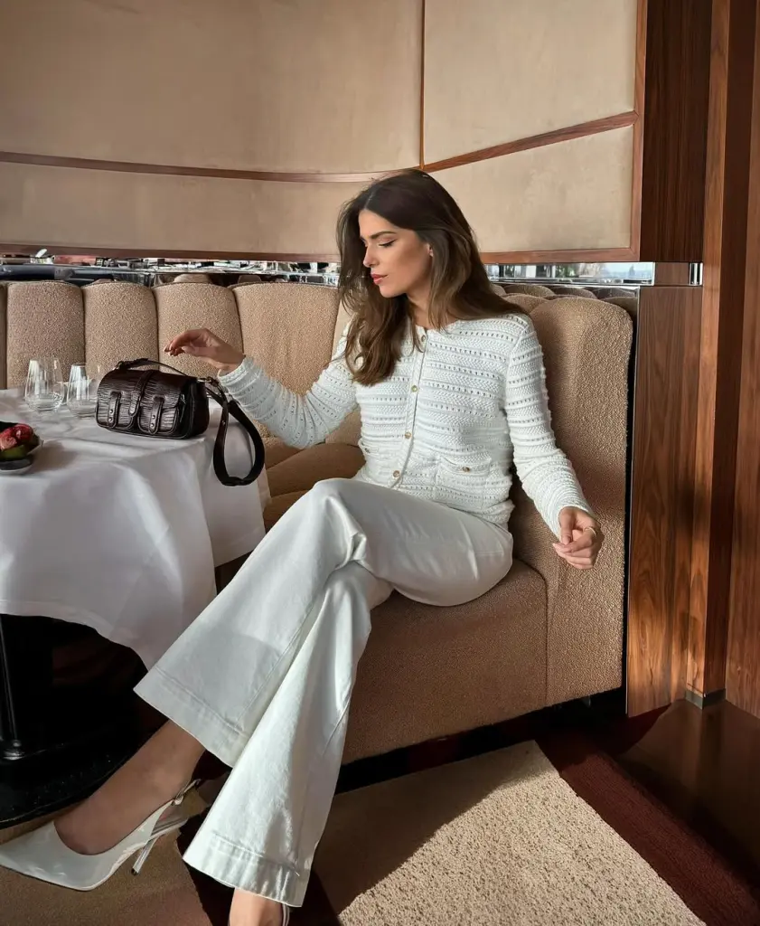 Elegant outfit with White textured cardigan, white wide-leg trousers, white pointed slingback heels and dark brown structured handbag