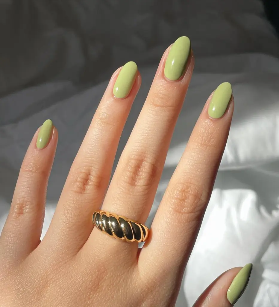 Short nails with glossy pistachio green polish for a fresh spring old money aesthetic
