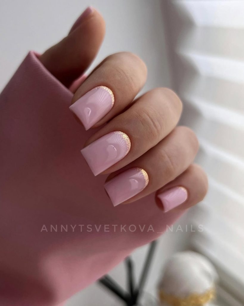 Long square nails with soft pink polish and chrome shimmer accent