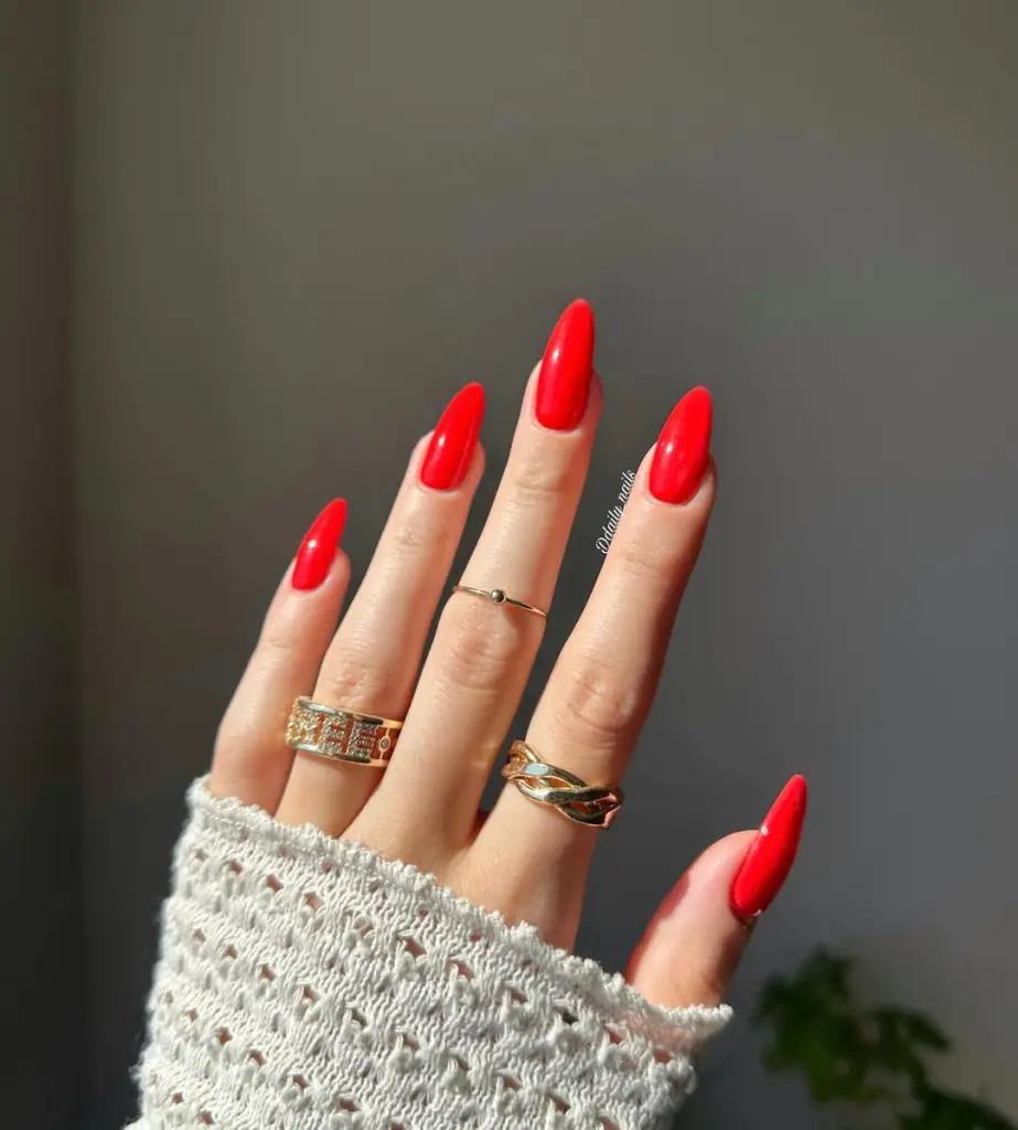 Almond shaped vibrant red nails with high-gloss finish showcasing timeless old money elegance for spring
