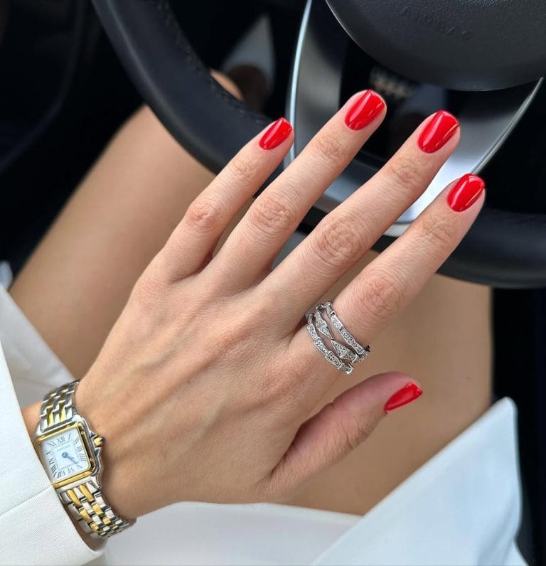 Short square nails with vibrant cherry red polish delivering timeless old money elegance perfect for spring with ultra-glossy finish