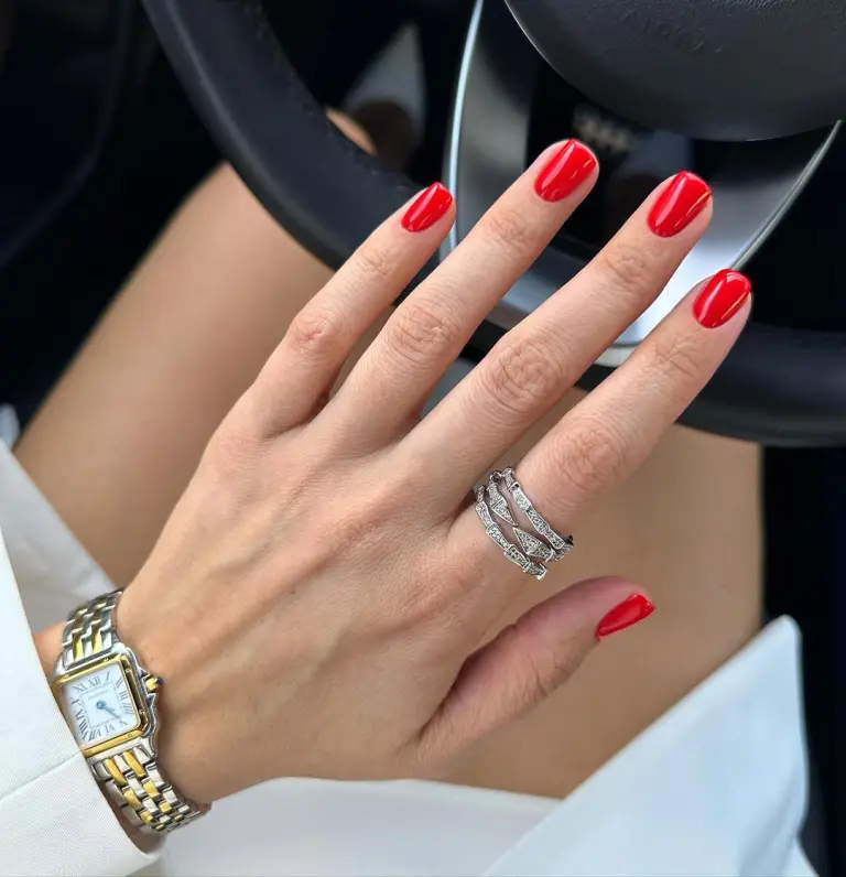 Short square nails with vibrant cherry red polish delivering timeless old money elegance perfect for spring with ultra-glossy finish