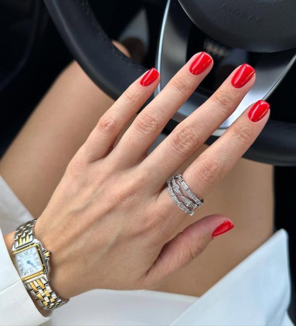 Short square nails with vibrant cherry red polish delivering timeless old money elegance perfect for spring with ultra-glossy finish