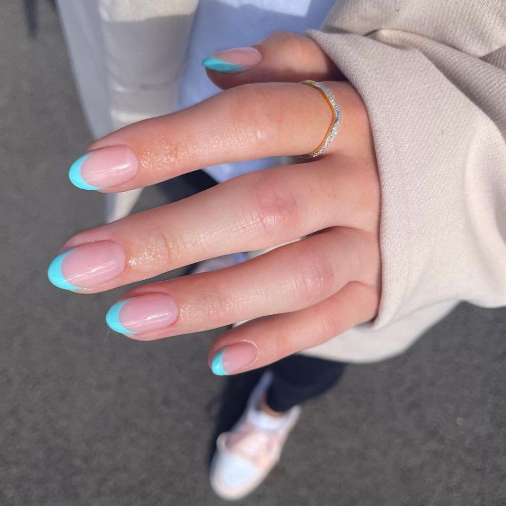 Clear base nails with turquoise French tips