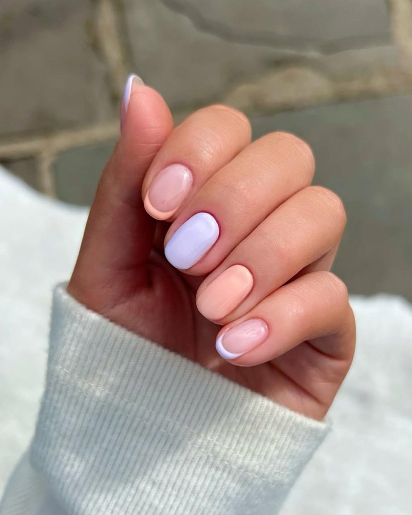Short pastel French tips with pastel blue accent nail