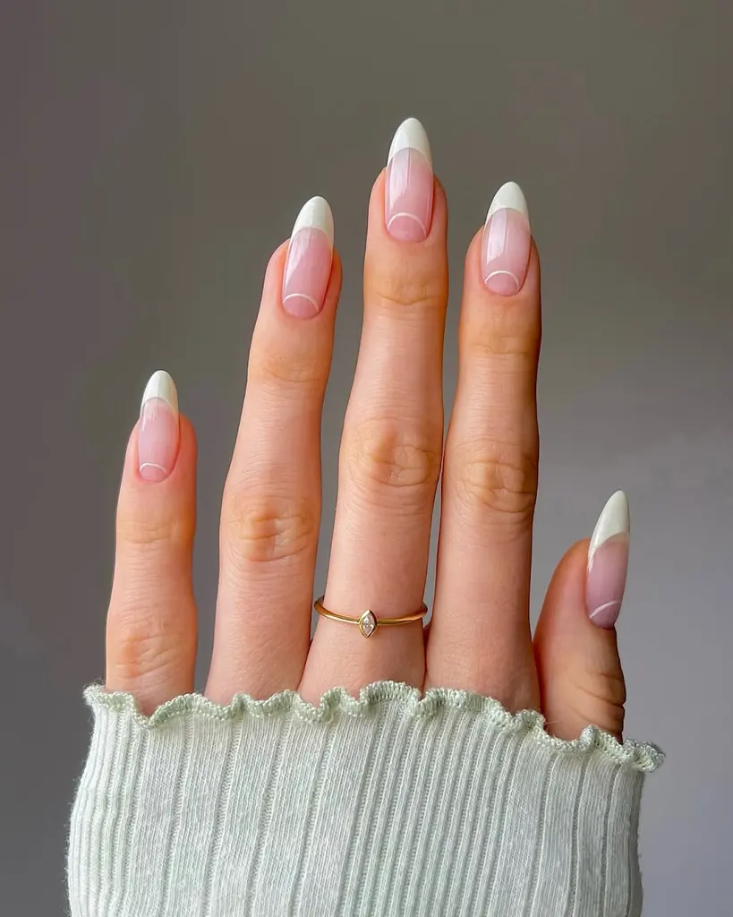 Almond french tip nails with sheer pink base
