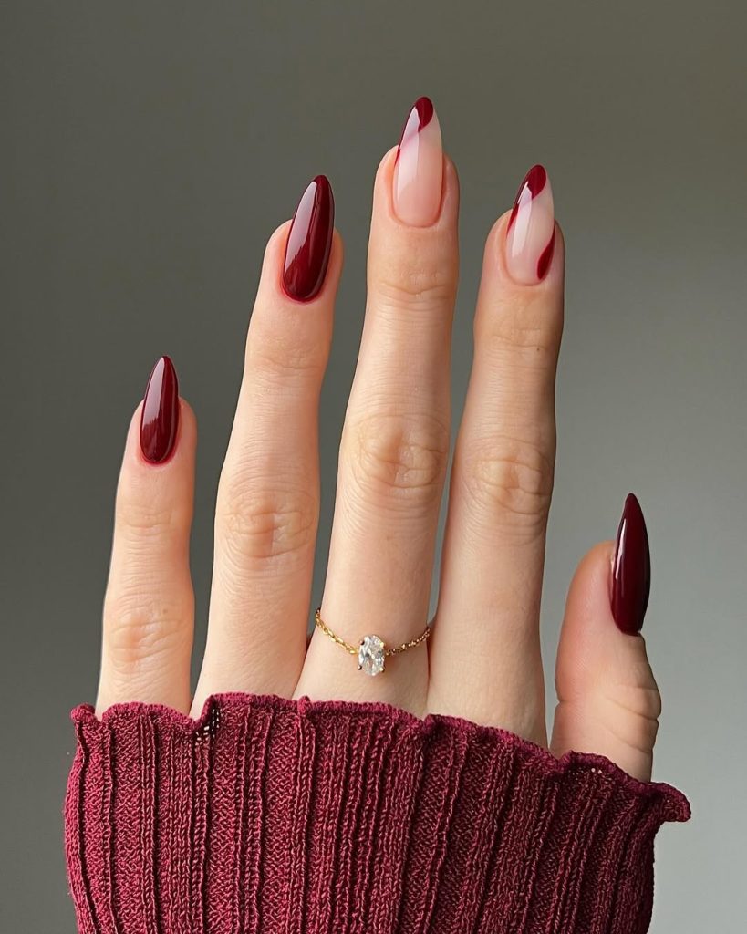 Long classy almond nails with deep burgundy swirls on a sheer pink base