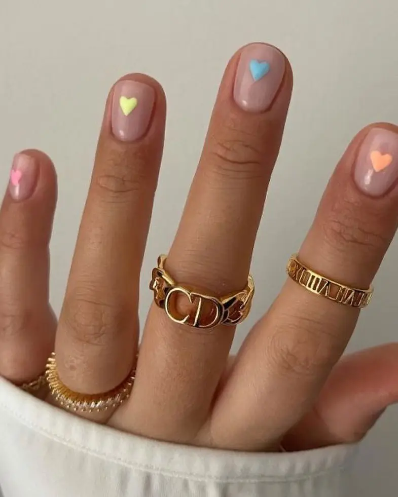 Short nude nails with colorful micro pastel hearts
