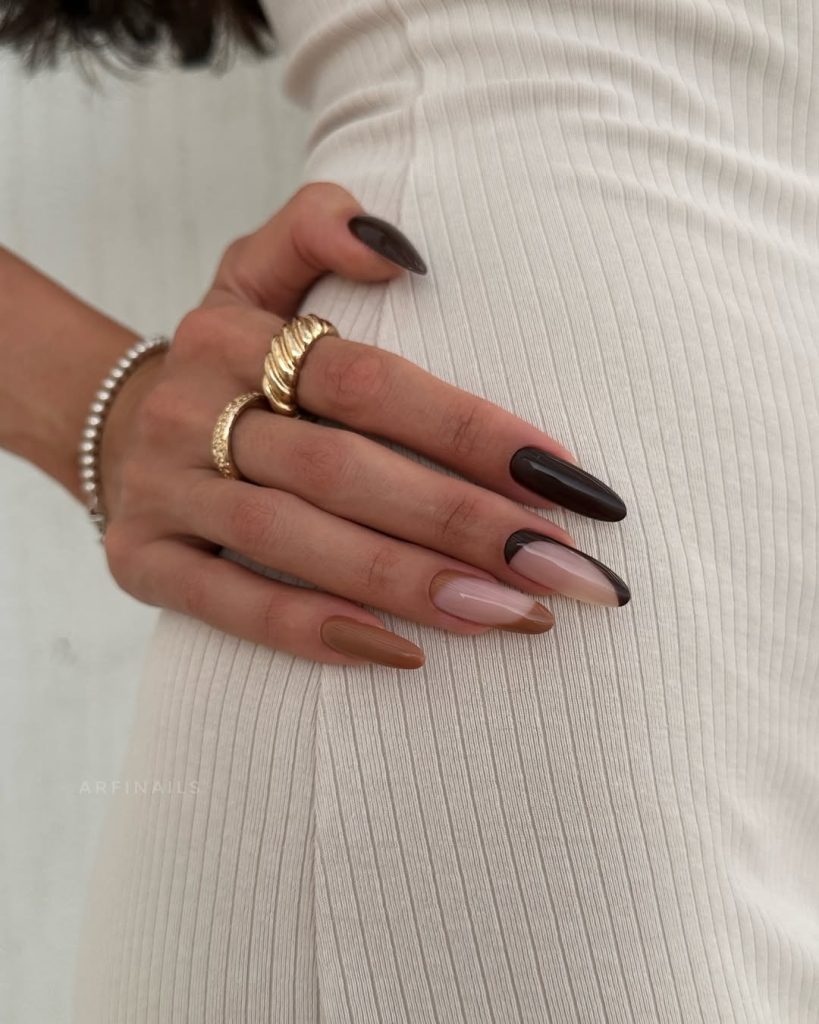 Long almond nails featuring chocolate brown and nude swirl designs
