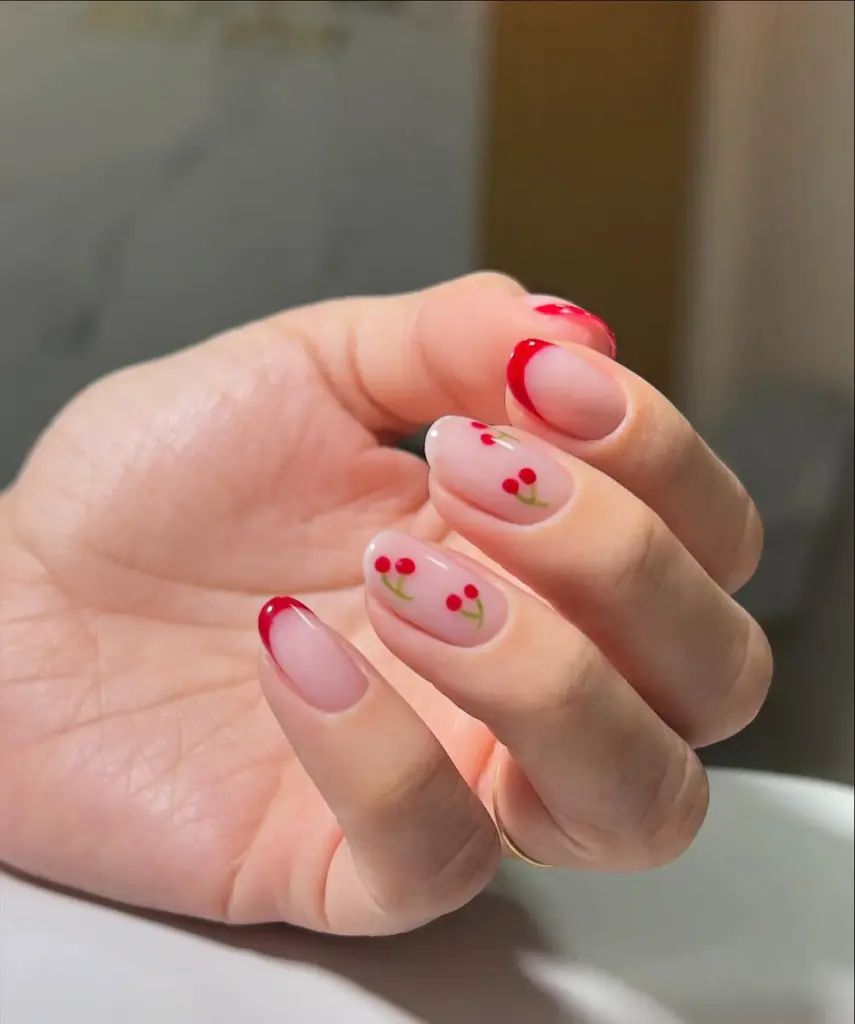 Classic red french manicure with minimal cherry design