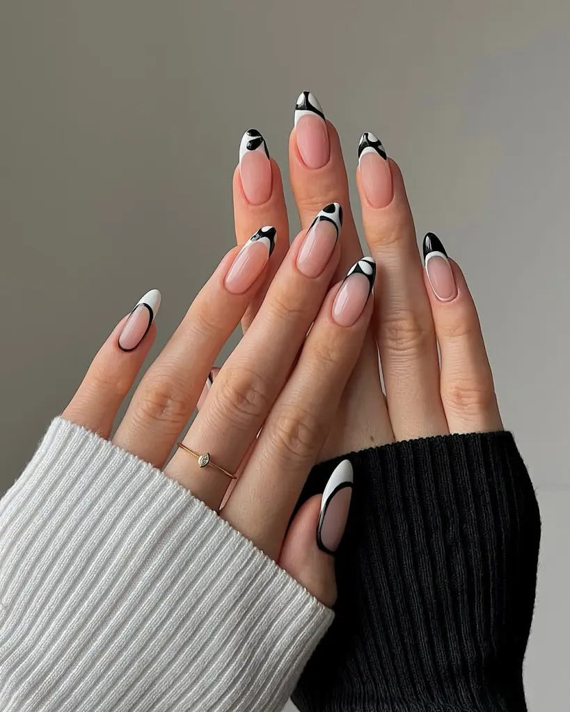 Oval french tip nails with black curved accent
