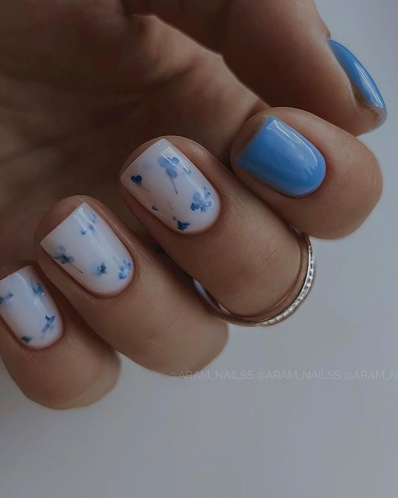 Short white nails with blue watercolor flowers