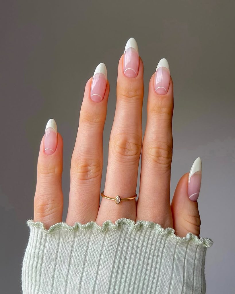 Almond shaped old money nails with white French tips and thin smile line