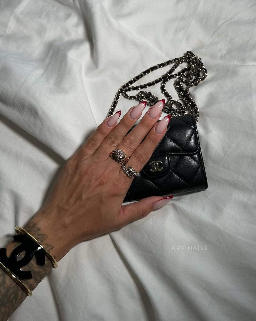 Long almond classy nails with red-tipped French manicure on sheer pink base