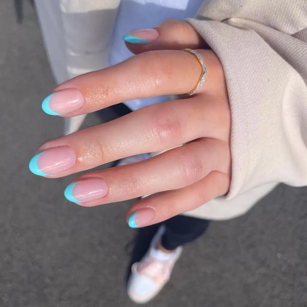 Oval french tip nails with blue tips
