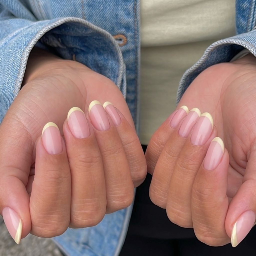 Oval french tip nails with yellow tips