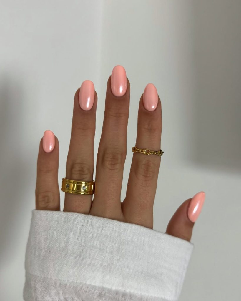 Milky peach oval nails with glossy finish
