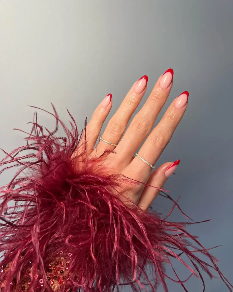 Almond french tip nails with bright red tips

