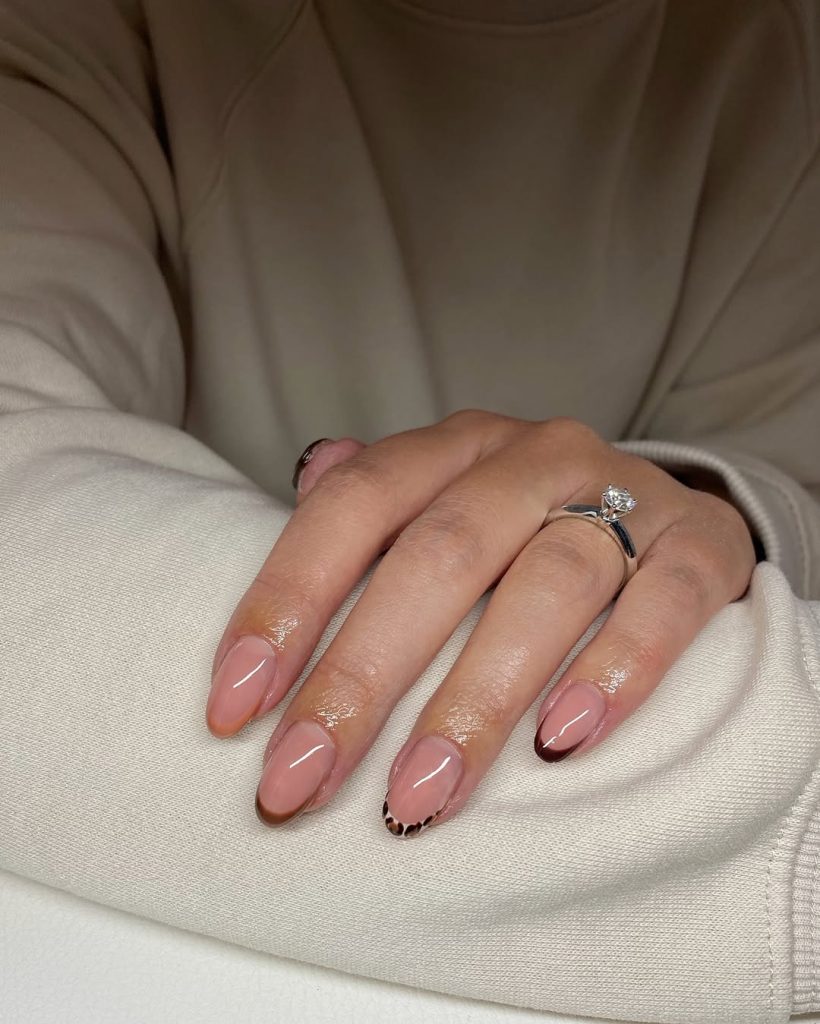 Almond french tip nails with leopard print and brown tips

