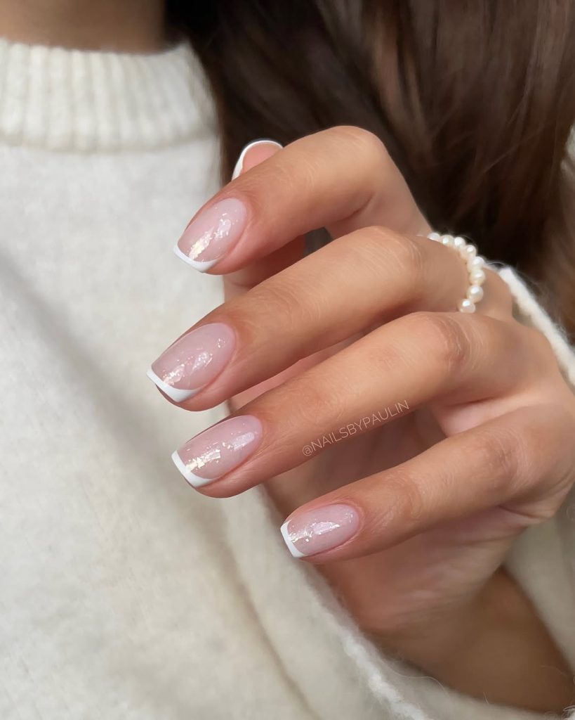 Short milky shimmery nails with withe french tips
