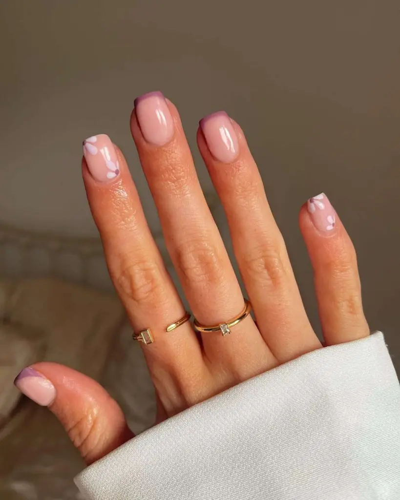 Short square  nails with sheer base, mauve French tips and white flower details
