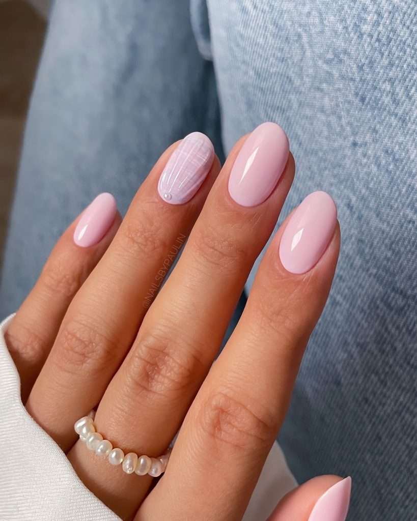 oval nails with pink base and white line design accent nail with pearl decoration