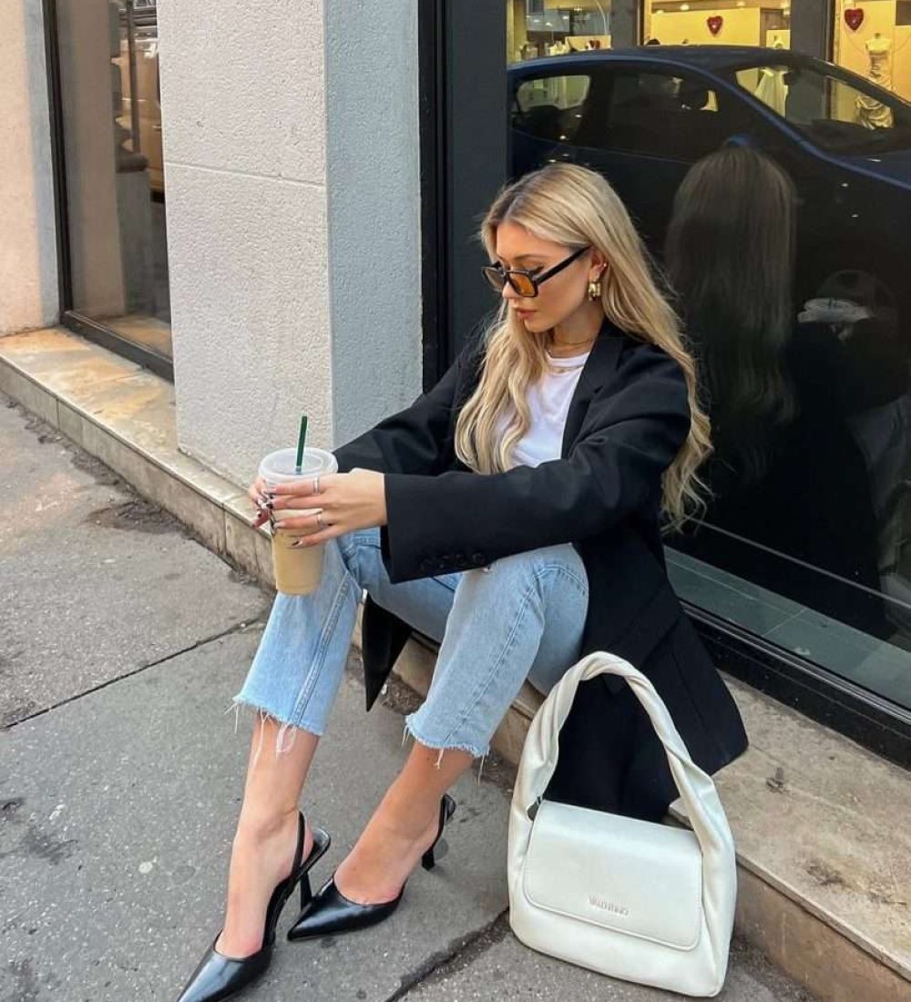 Classy spring outfit with black oversized blazer, white t-shirt, light wash cropped jeans, black slingback heels and cream shoulder bag