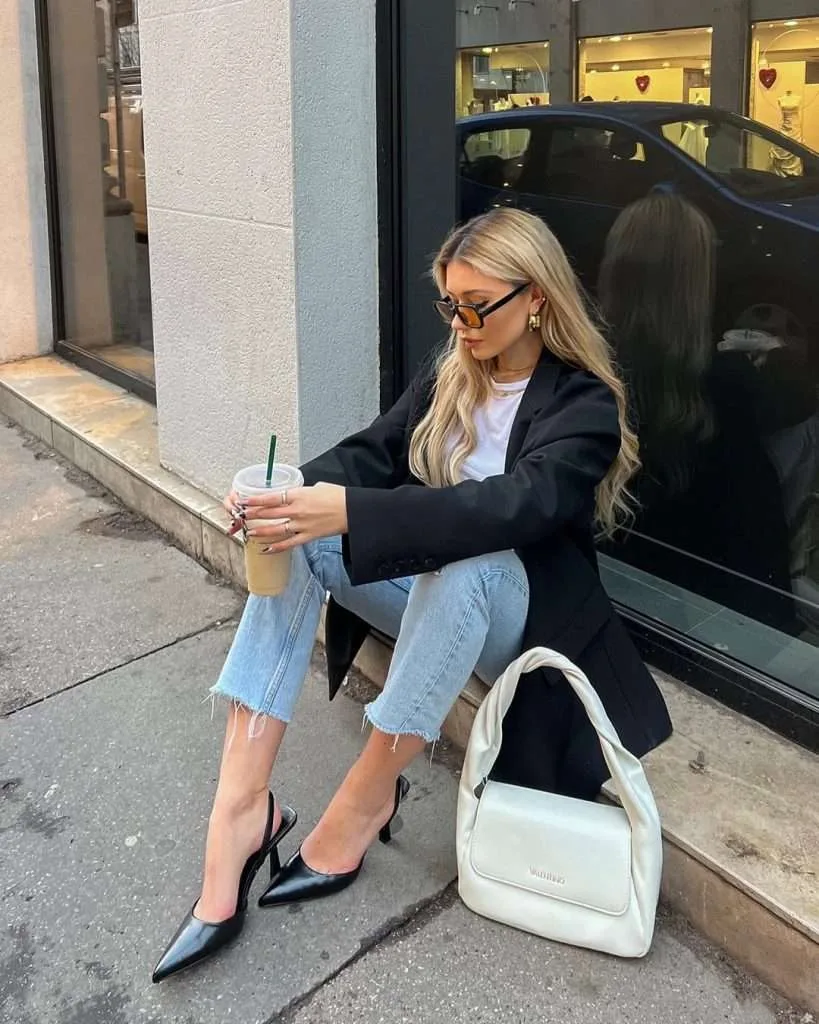 Classy spring outfit with black oversized blazer, white t-shirt, light wash cropped jeans, black slingback heels and cream shoulder bag