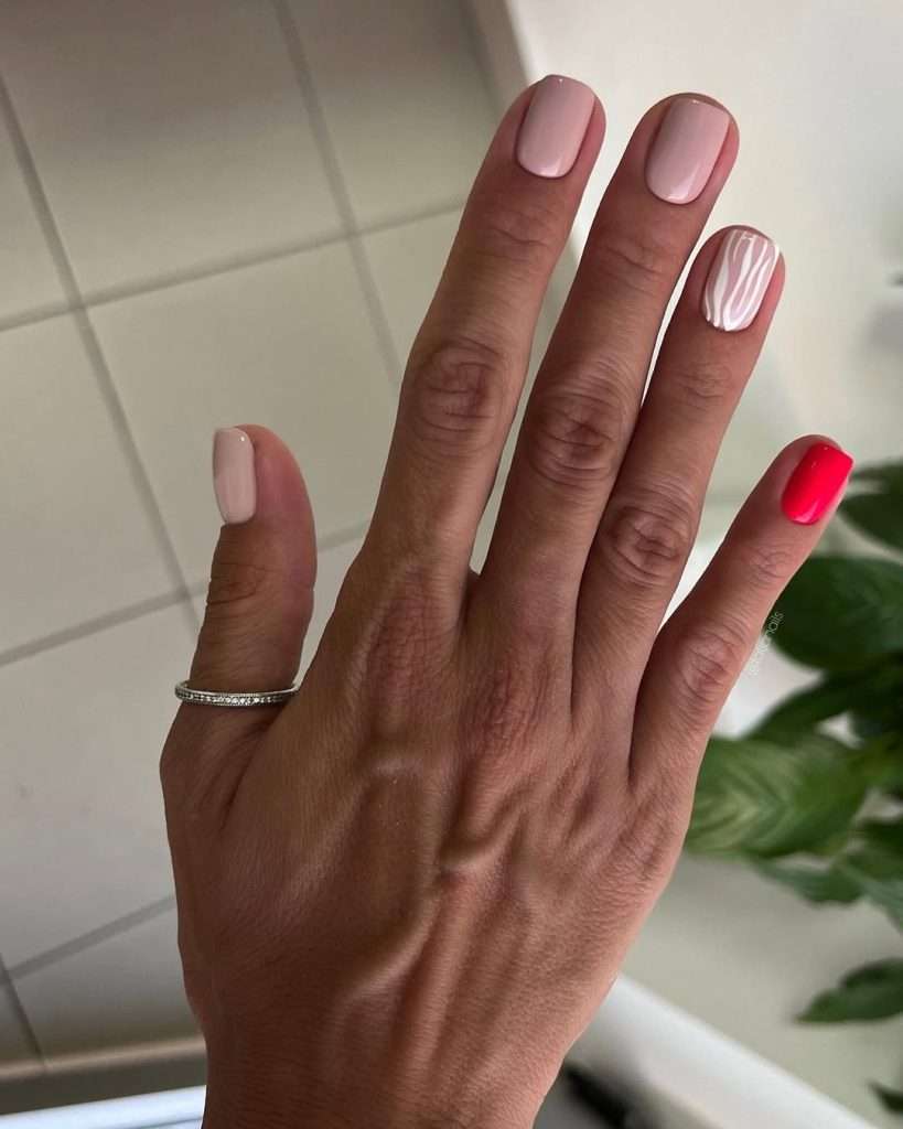 Short square nails in light pink with one white striped accent nail and one hot pink nail