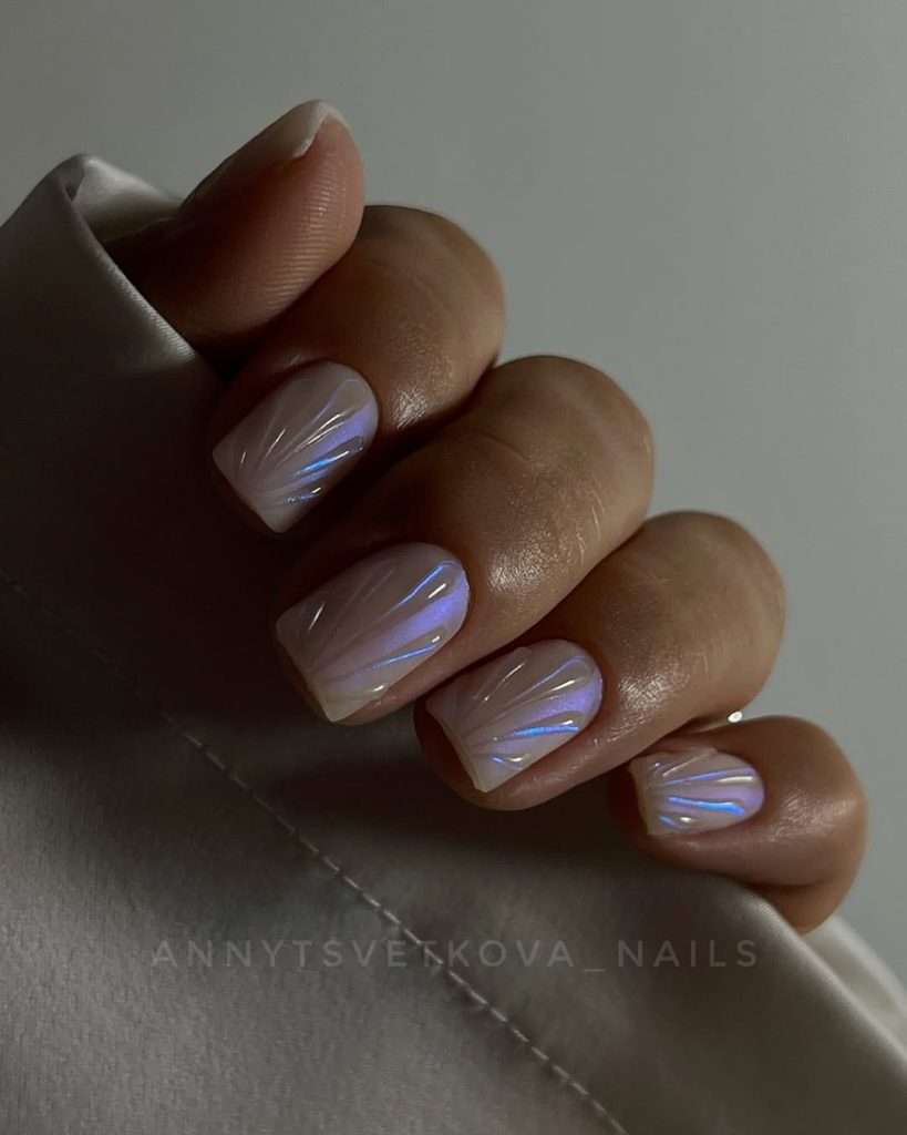 Short square nails with white base and iridescent chrome seashell design
