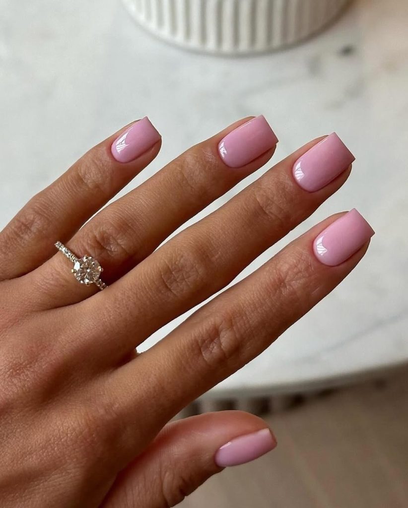 
Short square nails with uniform soft baby pink polish and glossy finish
