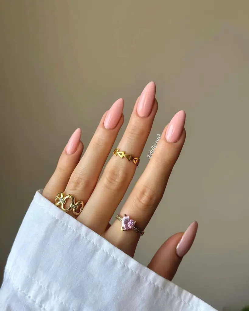 almond nails in glossy peach-pink polish
