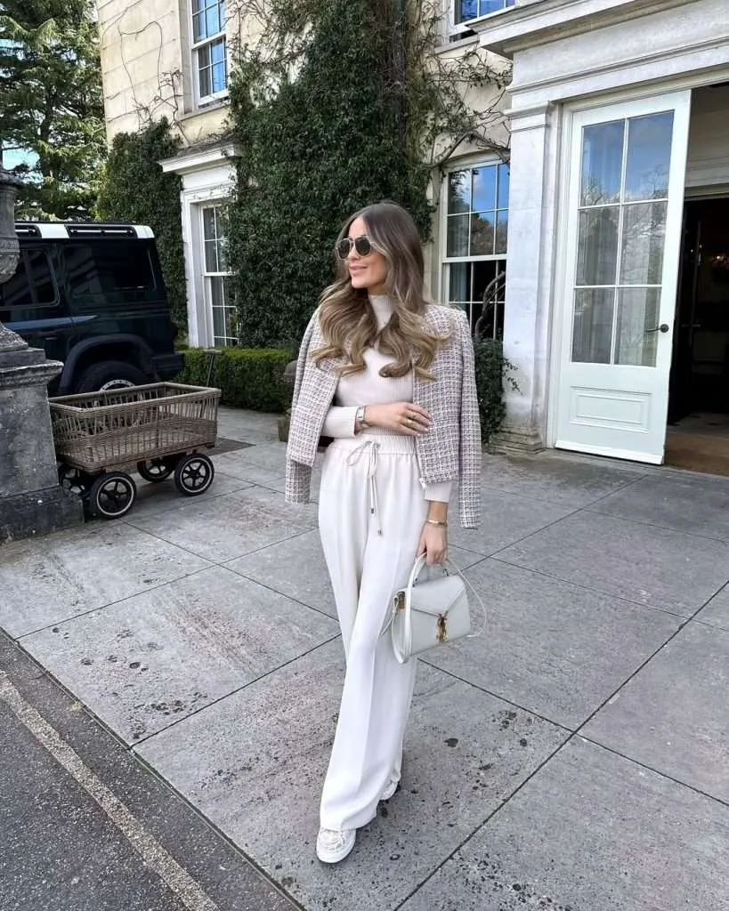 Classy spring outfit with cream tweed jacket, cream turtleneck, white wide-leg trousers, cream loafers and white Saint Laurent bag