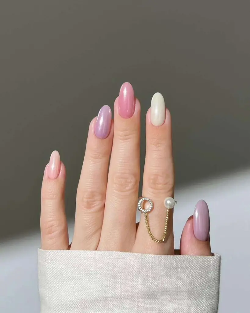 Medium almond nails with mixed pastel pink, lavender and pearl white polish
