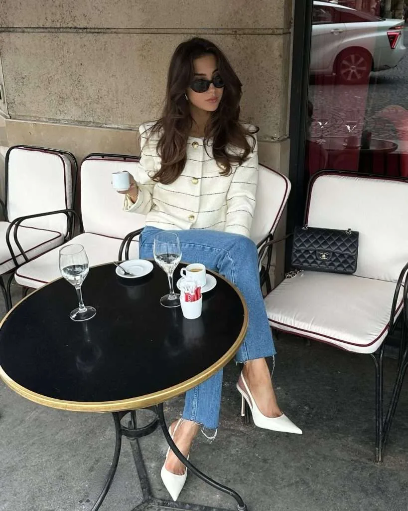 Classy spring outfit with white striped tweed jacket, light wash jeans, white slingback heels and black Chanel bag