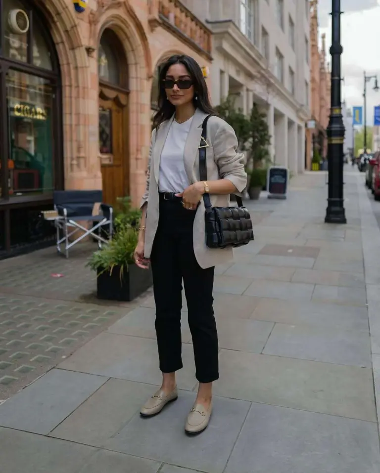 Business casual outfit with beige oversized blazer, white t-shirt, black ankle trousers, thin belt, beige loafers and black quilted crossbody bag