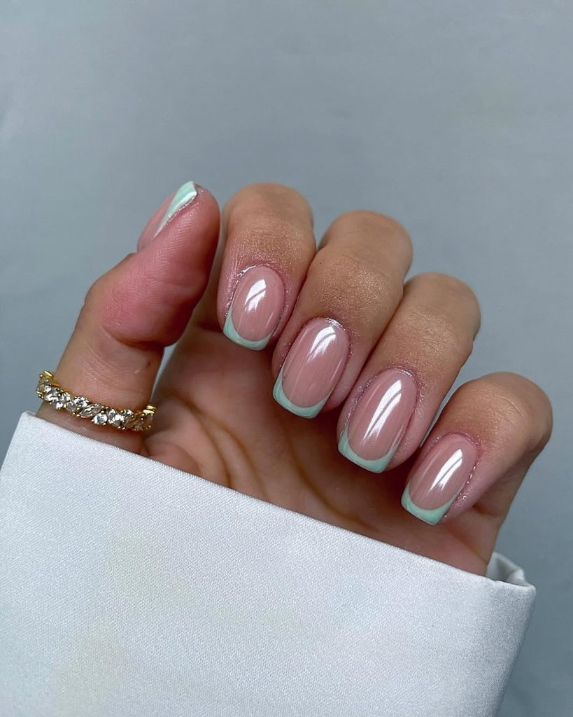 Square nails with pink base and pale sage green French tips featuring a glazed donut finish
