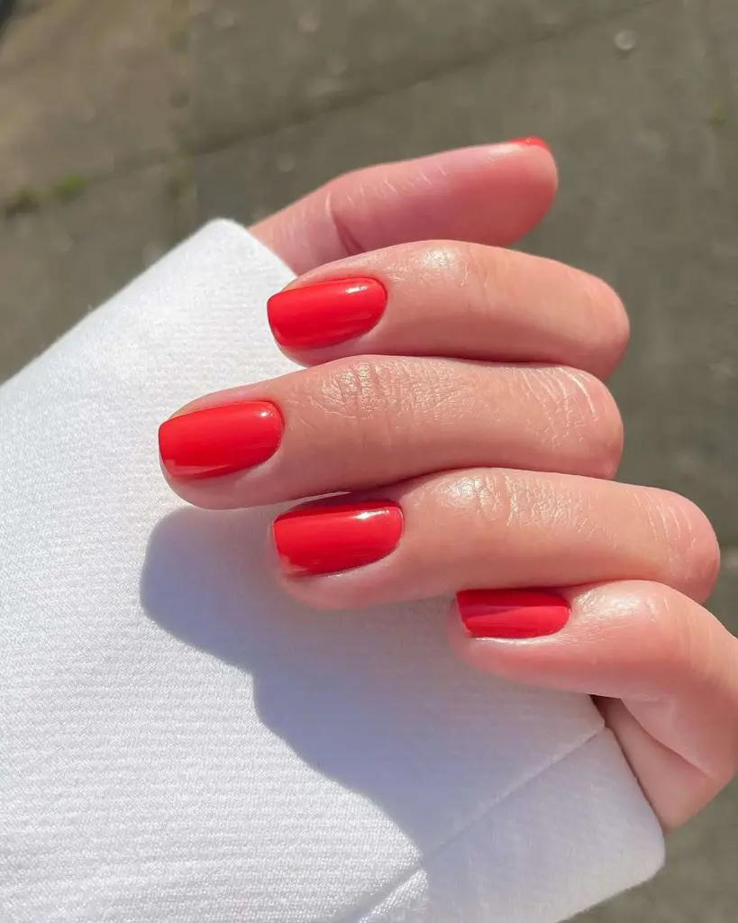 Short square nails in glossy vibrant red polish