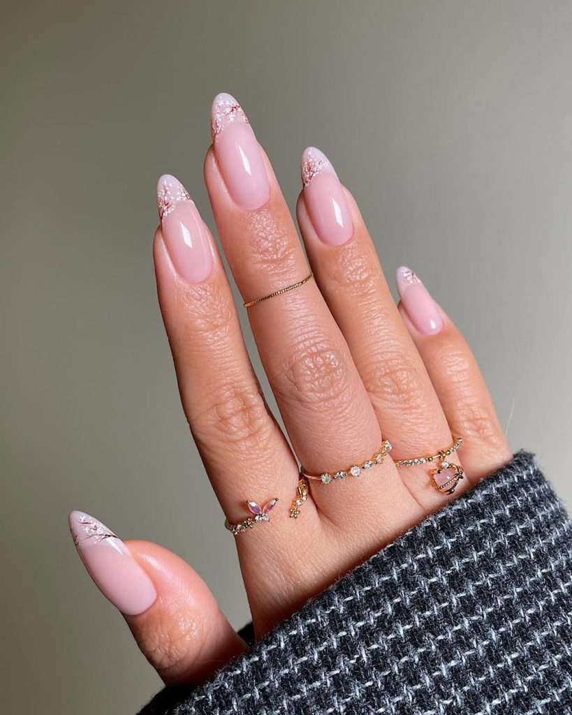 Almond nails with pink base and cherry blossom floral tip designs
