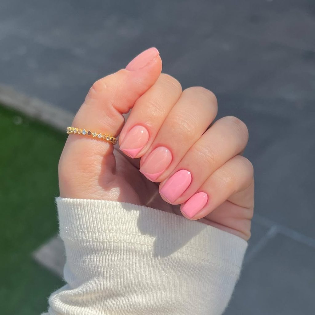 Short square nails with pink sides on two accent nails and solid pink on remaining nails 