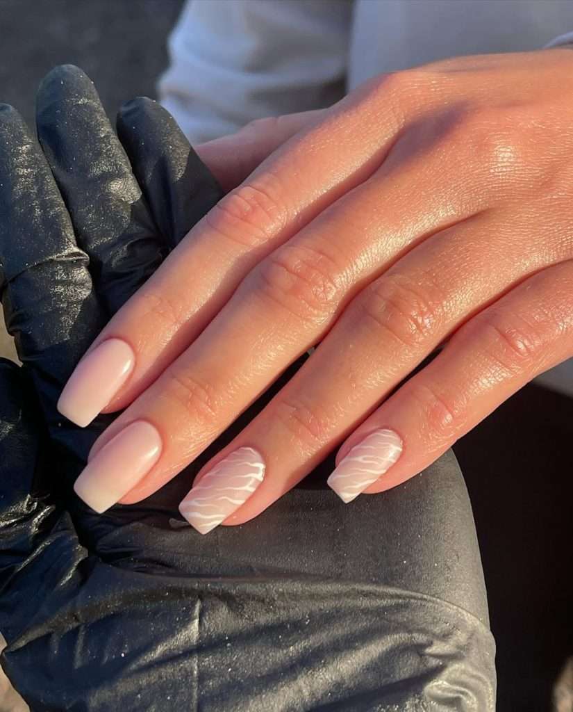 Long square nude nails with white wavy line design on accent nail 