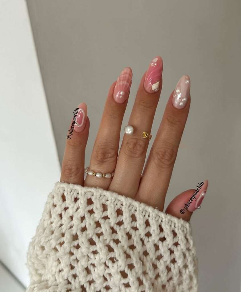 Long almond nails with pink gradient base, 3D white seashell design and pearl decorations
