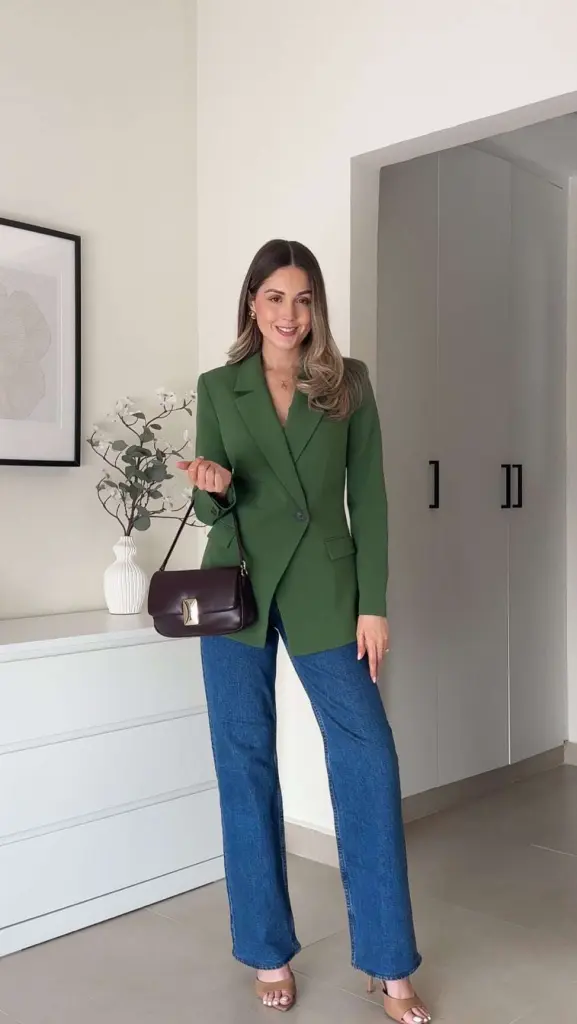 Business casual outfit with green fitted blazer, wide-leg blue jeans, nude sandal heels and brown crossbody bag