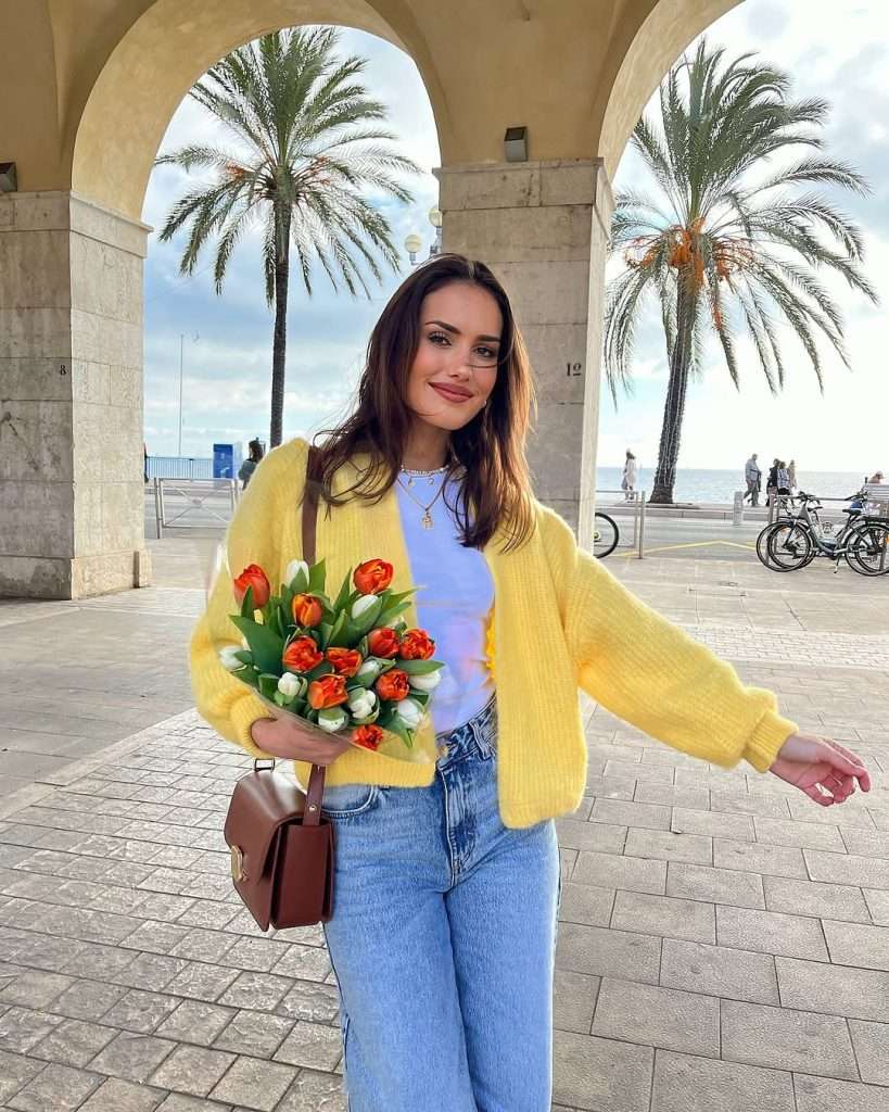 Fresh spring outfit with yellow cardigan, white tank top, light wash straight leg jeans and brown leather shoulder bag
