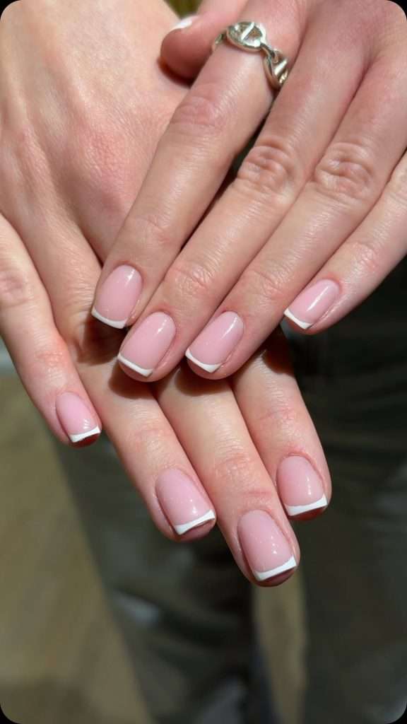 Short square nails with pink base and classic white French tips