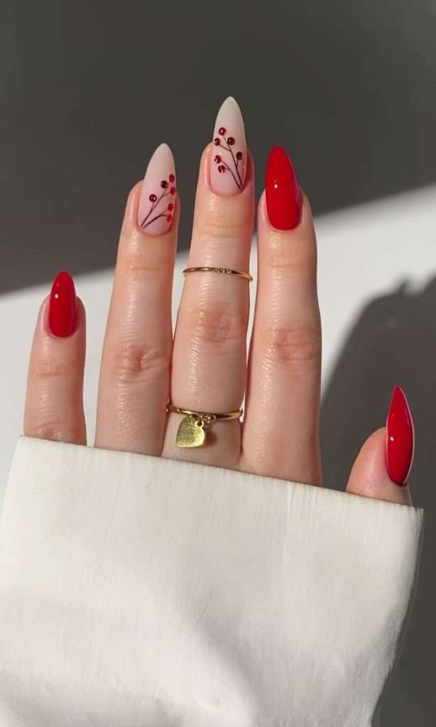  Long almond nails with red polish and pink base accent nails featuring hand-painted red berry branch design
